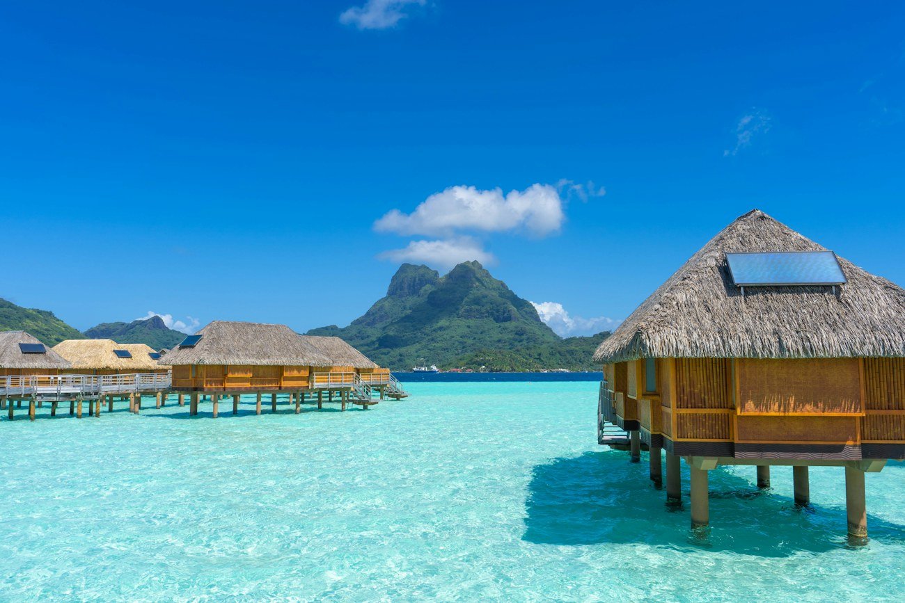 Overwater bungalows above turquoise water in Bora Bora